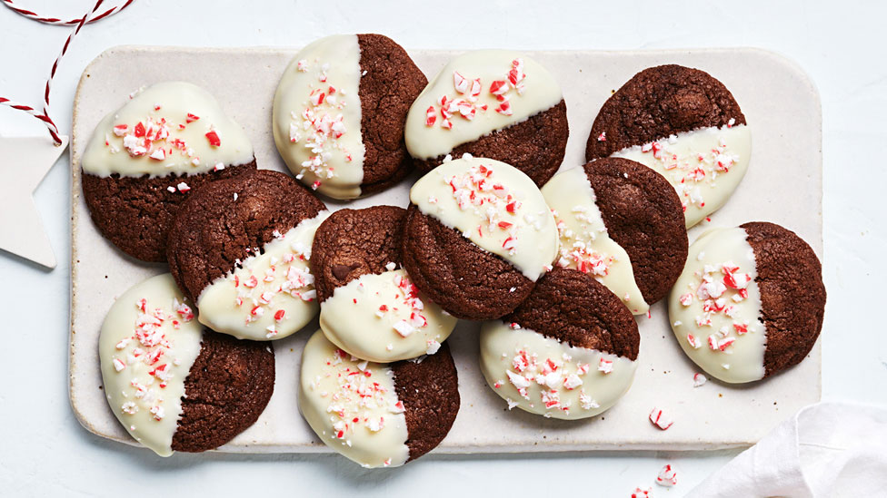 A tray of chocolate and candy cane cookies sprinkled with more crushed candy canes