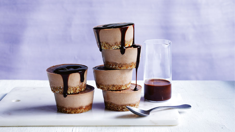 A stack of raw peanut butter chocolate cheesecakes
