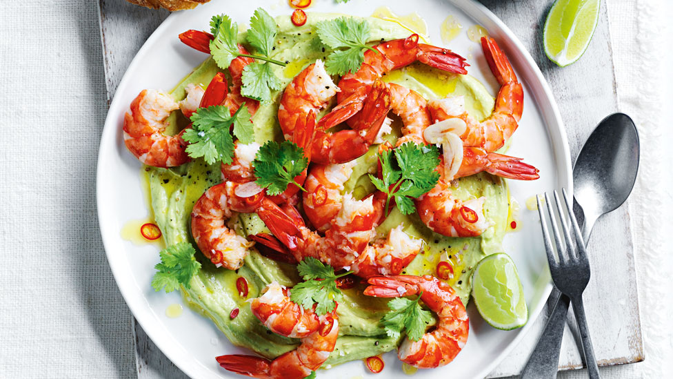 A prawn platter salad with avocado served with lemon