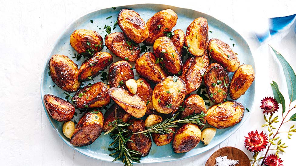 Roast potatoes and rosemary on a dish.