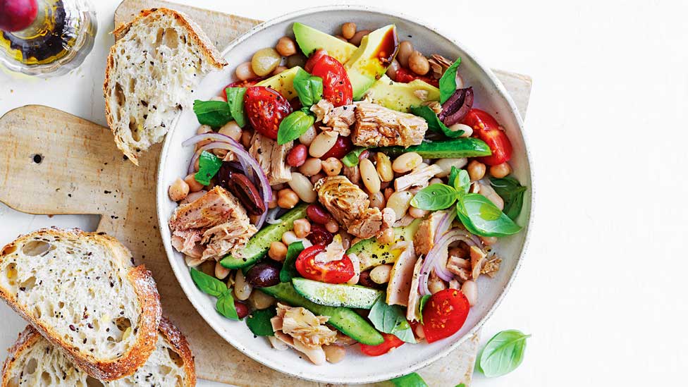 Tuna and bean salad in a bowl served with crusty bread