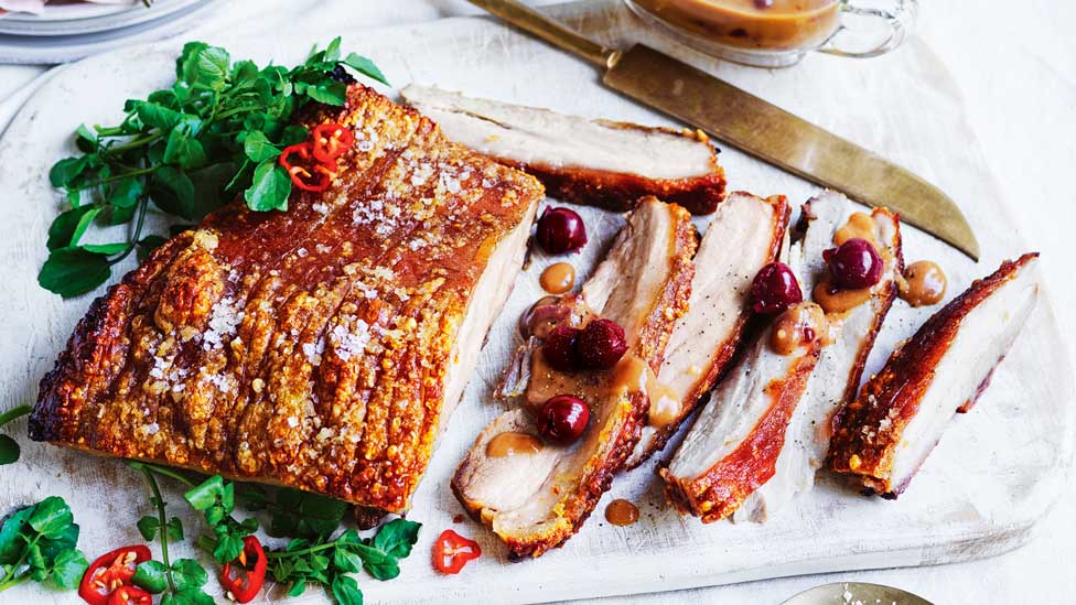 Slices of pork belly with cherry gravy.