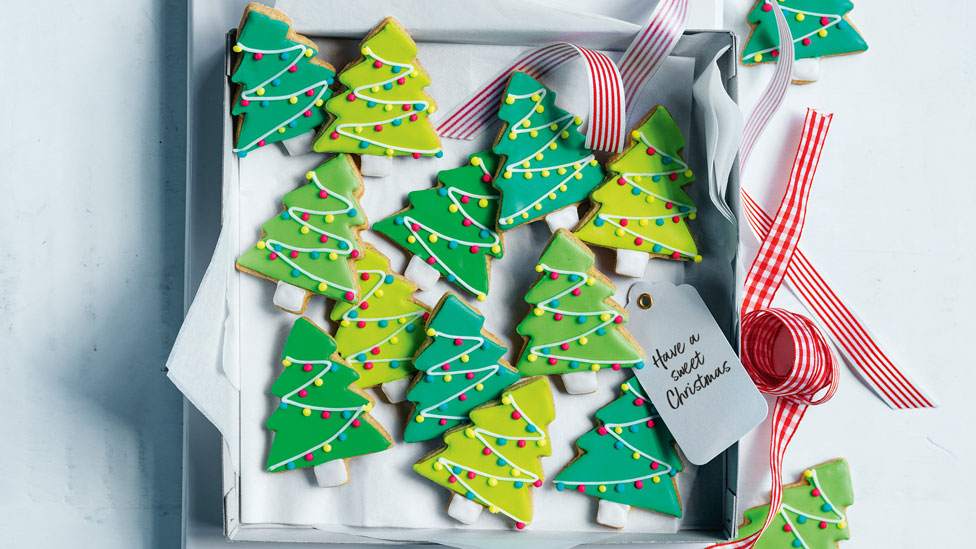 Christmas tree shapped short breads on a tray with a ribbon