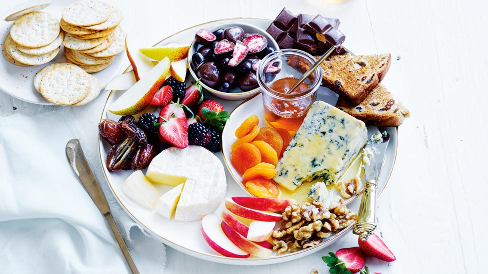 Date night cheese board with assorted fruit.