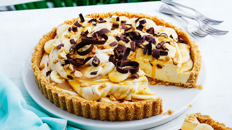 Banana cream pie with maple caramel cut in wedges