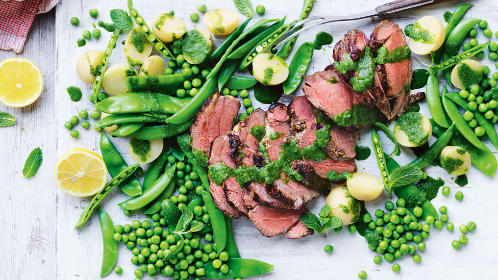 Thickly sliced BBQ lamb with pea salad and mint sauce