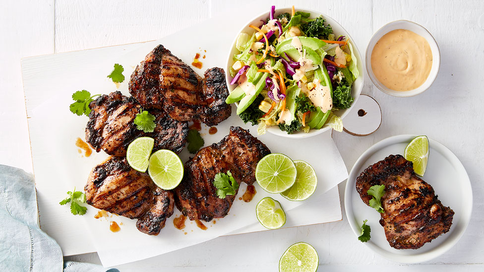 Jerk chicken and slaw with lemon wedges