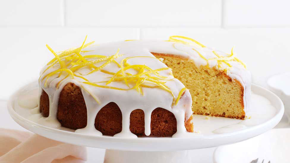 Lemon and cardamom drizzle cake cut in wedges