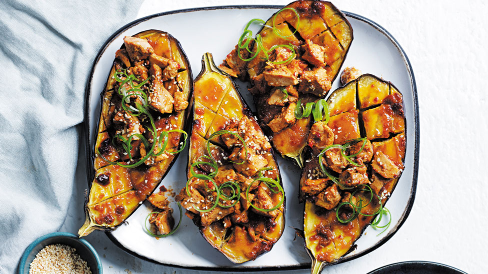 Two miso eggplant cut in half with scrambled tofu