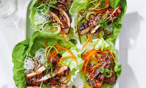 Four cups of lettuce filled with korean styled bbq chicken