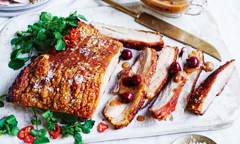 Slices of pork belly with cherry gravy.