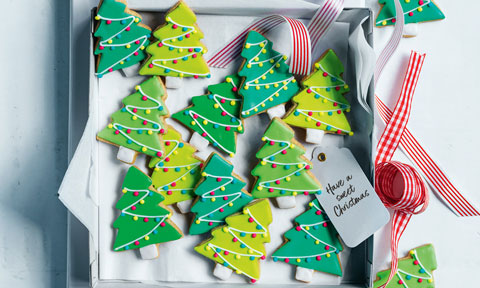 Christmas tree shapped short breads on a tray with a ribbon