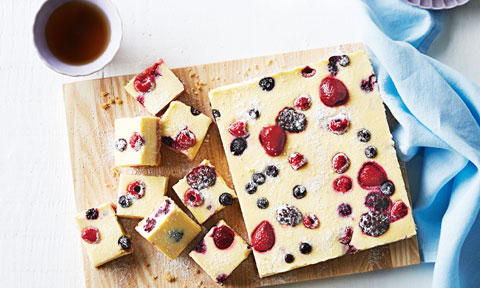 Slices of condensed milk cheesecake on a chopping board.