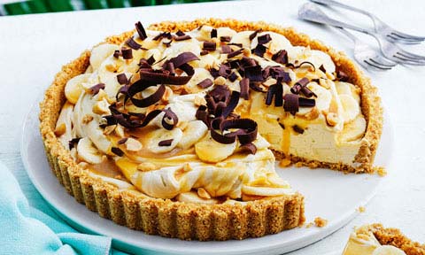 Banana cream pie with maple caramel cut in wedges
