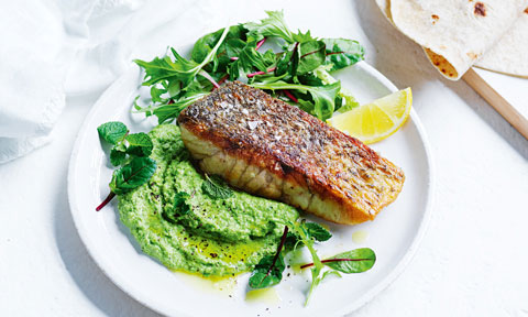 Crispy lemon fish with pea hommus and salad leaves