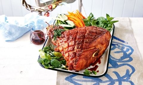 Sweet and spicy glazed ham on a baking tray
