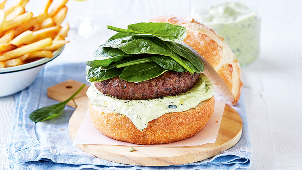 An open burger with spinach and fetta, served with fries