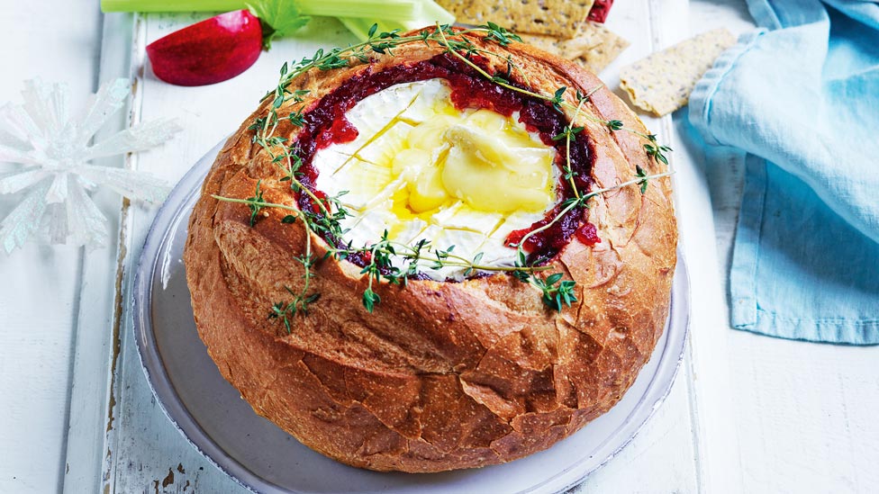Baked brie cob with cranberry sauce in a loaf