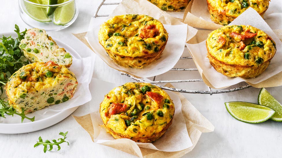 Five cheesy salmon frittatas on baking papers