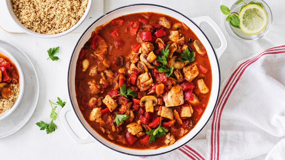 Chicken cacciatore sprinkled with parsely sprigs