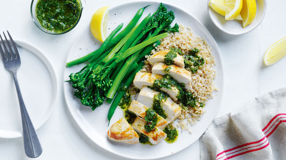 Chicken and baby broccoli on rice drizzled with chimichurri