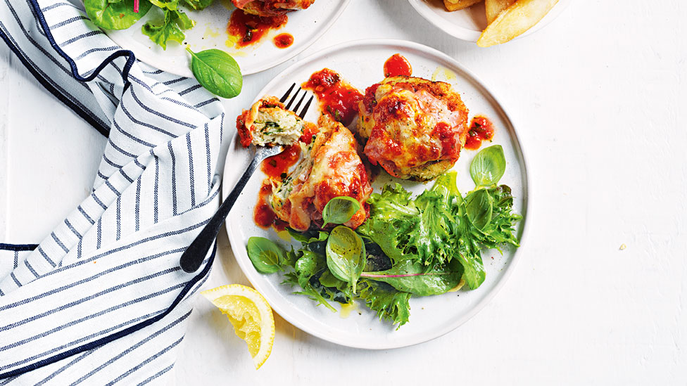 Chicken parmigiana rissoles with salad leaves and chips