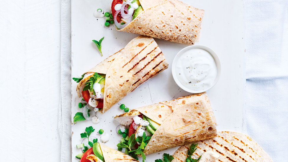 Three chicken wraps with herb salad