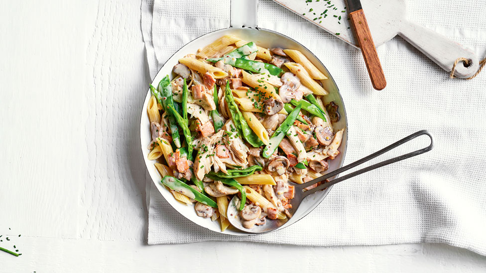 Creamy chicken and snow pea penne dish sprinkled with chives