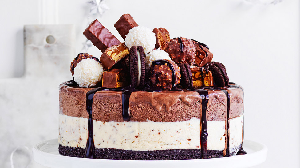 No-cook chocolate ice cream cake topped with choclates and biscuits