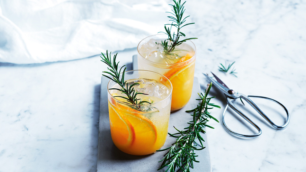 Orange and rosemary gin and tonic serve with rosemary