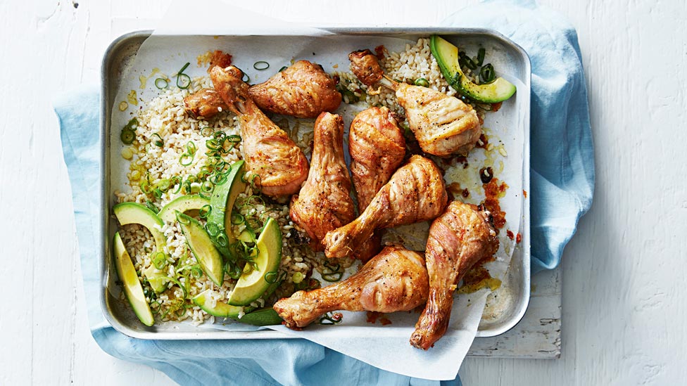 Curtis’ roast chicken drumsticks with avocado on top of rice, sprinkled with salt and pepper