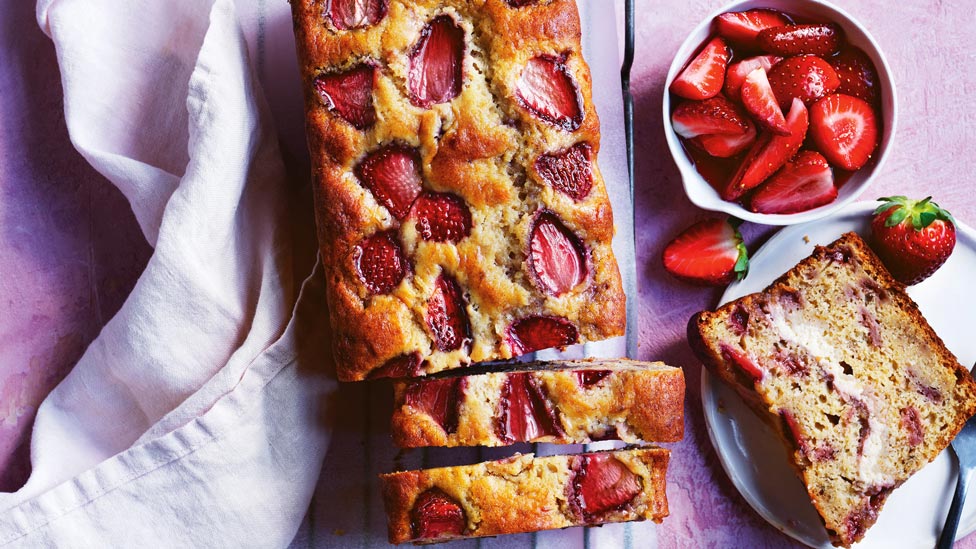 Strawberry cheesecake and banana bread served with extra strawberries