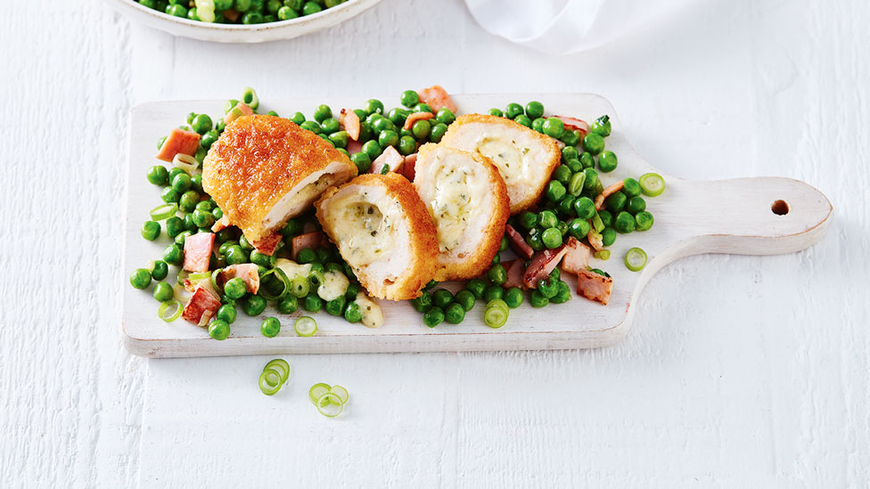 Chicken Kiev thickly sliced with pea salad