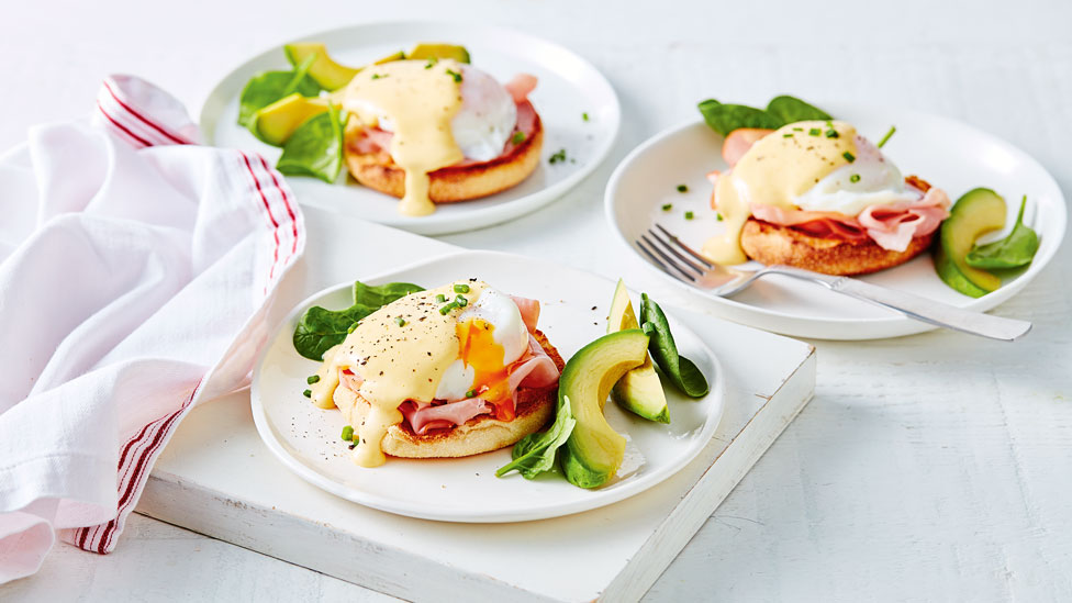 3 plates with toast, a poached egg, ham, avocado and hollandaise sauce