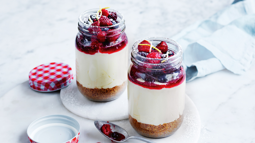Two no bake berry and white choc cheesecakes set in jars