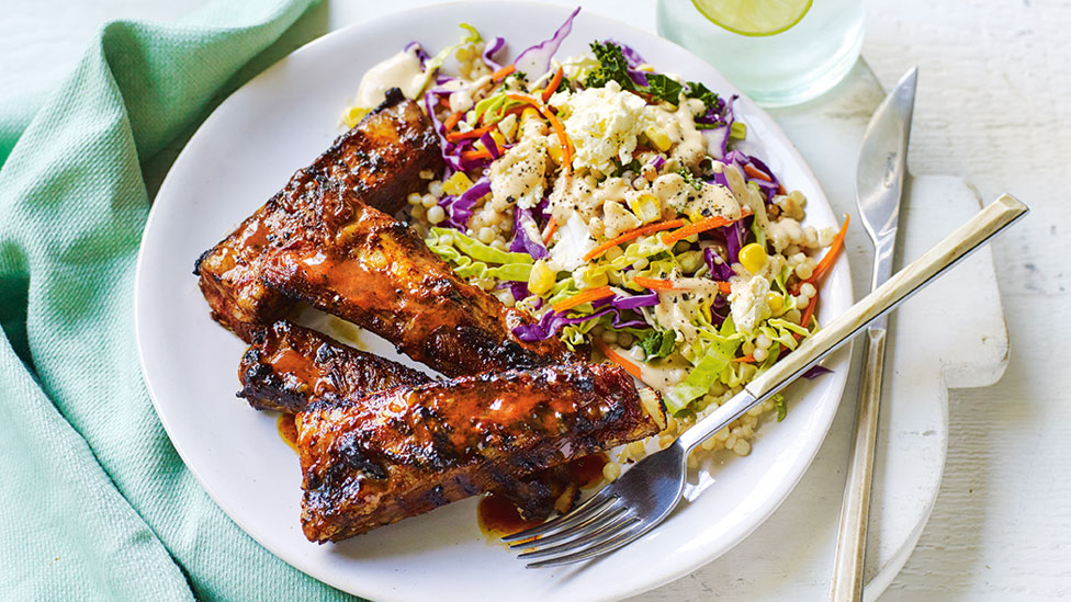 Four sticky BBQ lamb ribs with pearl couscous and salads