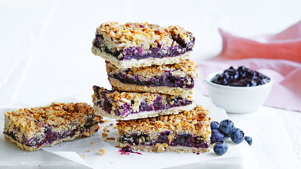 Stack of blueberry granola bars with blueberries jam