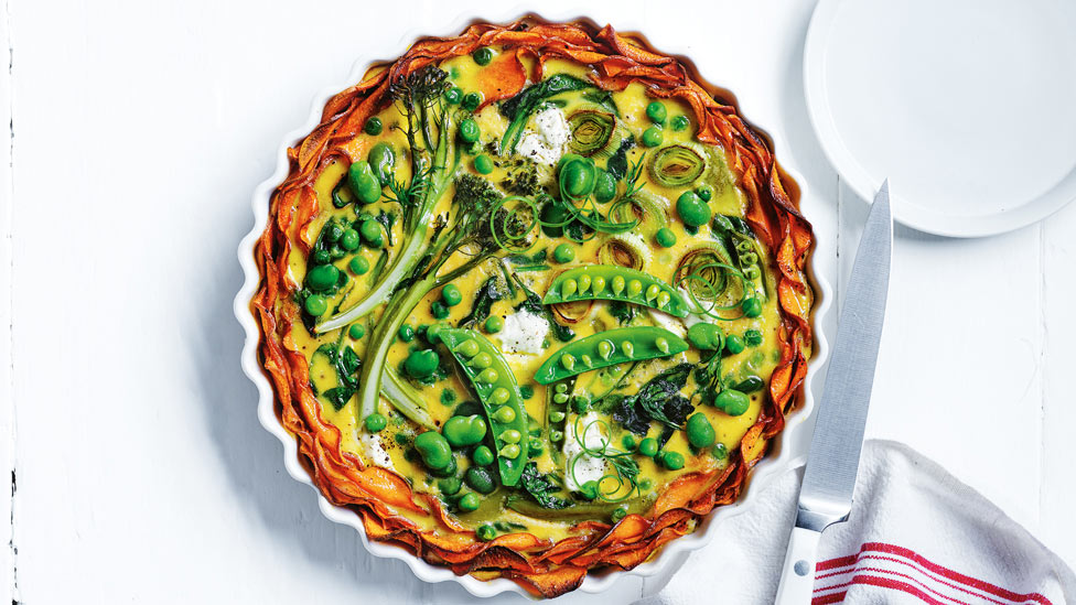 Spring veg quiche with sweet potato crust in a baking pan
