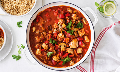 Chicken cacciatore sprinkled with parsely sprigs