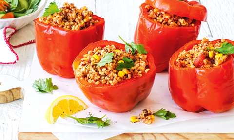 Four chicken and two-grain stuffed capsicums with salad and lemon wedges