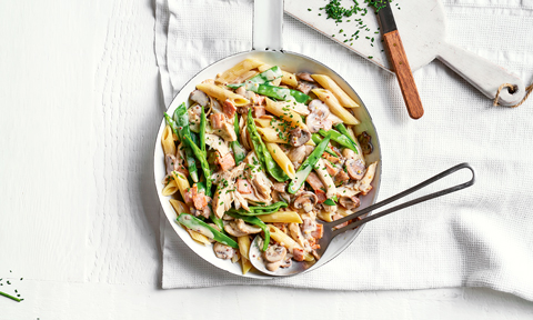 Creamy chicken and snow pea penne dish sprinkled with chives