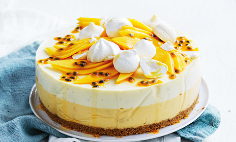 Layered mango and passionfruit cheesecake topped with meringues