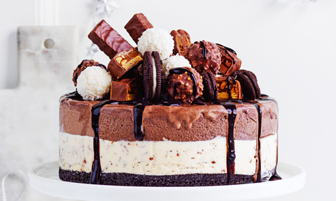 No-cook chocolate ice cream cake topped with choclates and biscuits