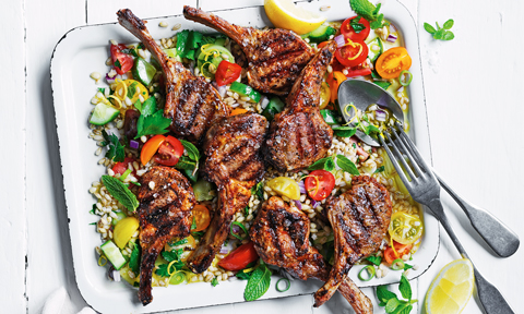 Lamb chops served on top of salad greens with cherry tomatoes