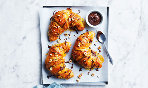 Three chocolate and orange croissants with almonds and chocolate