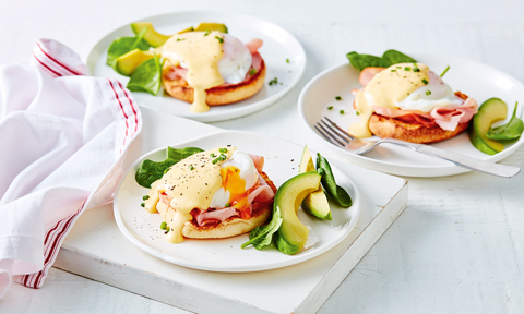 3 plates with toast, a poached egg, ham, avocado and hollandaise sauce