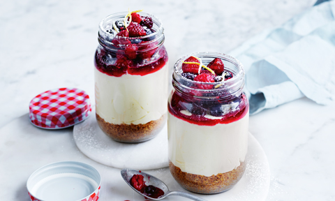 Two no bake berry and white choc cheesecakes set in jars