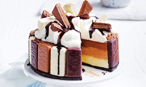 A tim tam cheesecake topped with more tim tams and chocolate drizzle