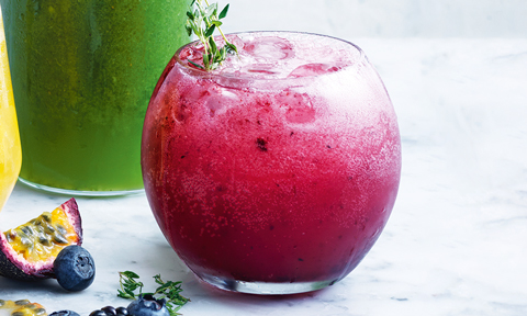 Blueberry and blackberry spritz topped with ice and thyme sprigs