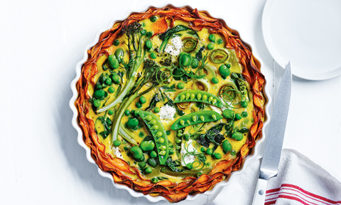Spring veg quiche with sweet potato crust in a baking pan